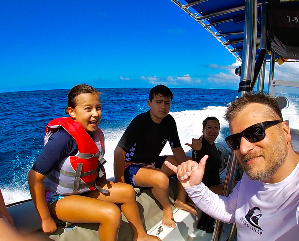 Lance and family on a boat